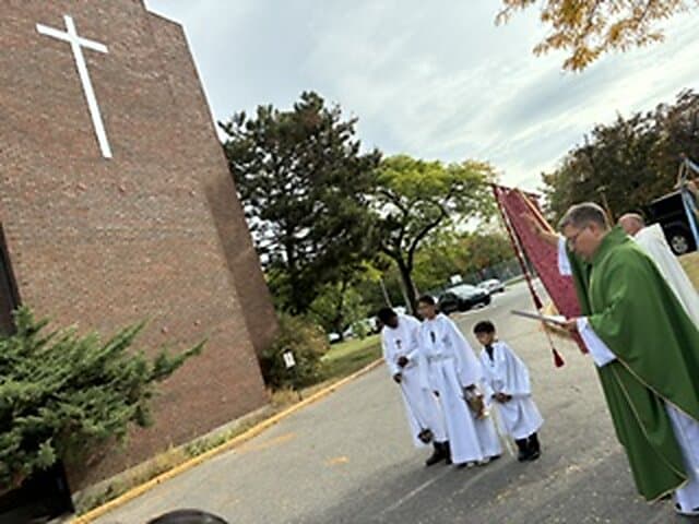 Blessing of the new cross outside Église Sainte-Angèle