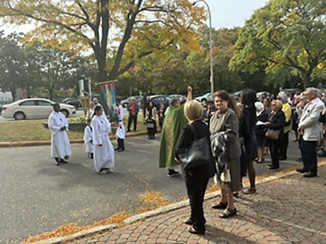 Blessing of the new cross outside Église Sainte-Angèle