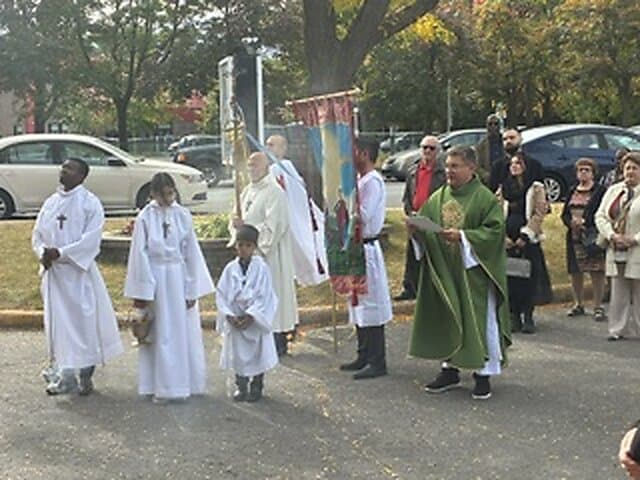 Blessing of the new cross outside Église Sainte-Angèle