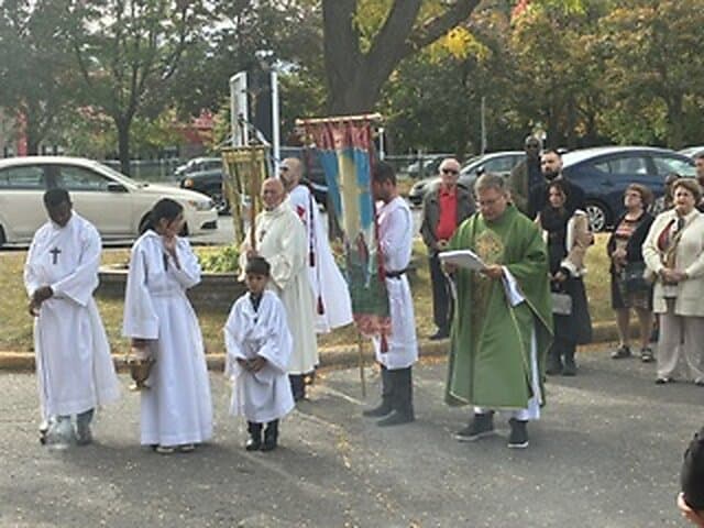 Blessing of the new cross outside Église Sainte-Angèle