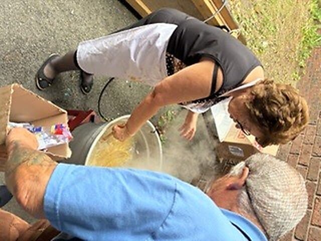 Volunteers cooking and serving the spaghetti dinner