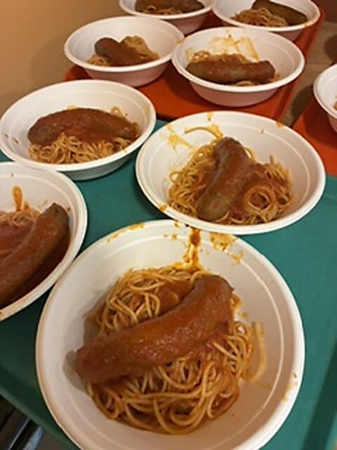 Plates of spaghetti with sausage at the dinner