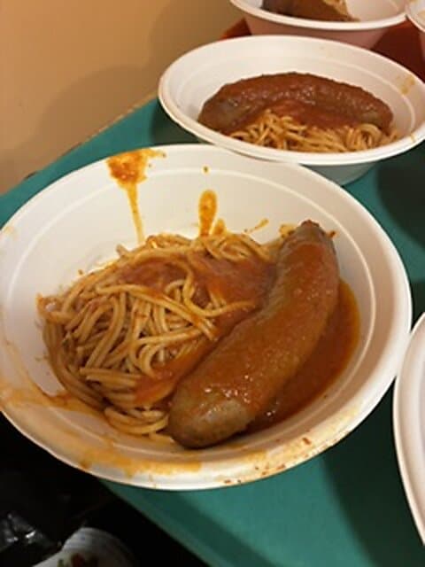 Plates of spaghetti with sausage at the dinner